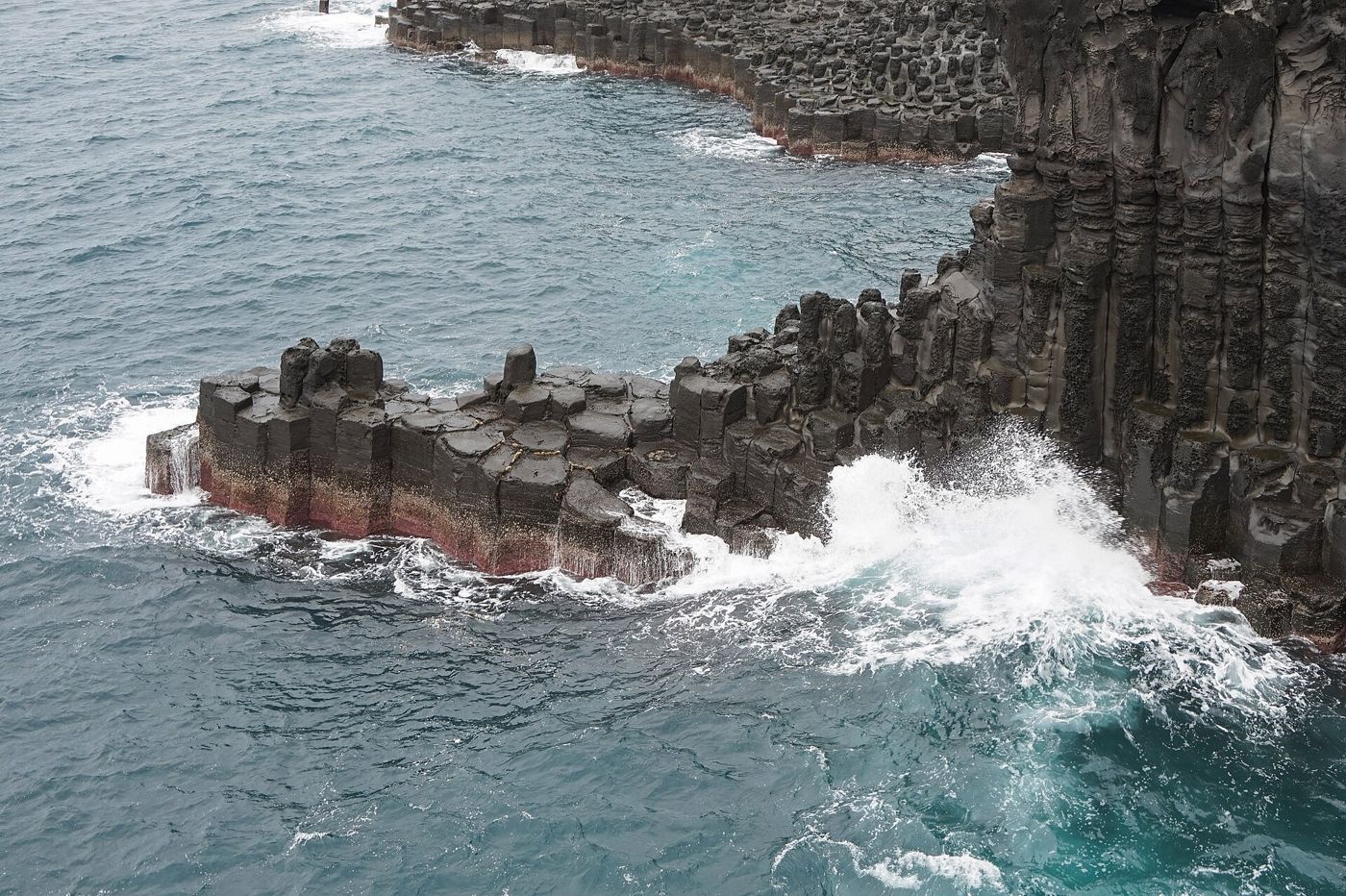 Waves against the basalt columns of the Daepo Jusangjeolli Cliff