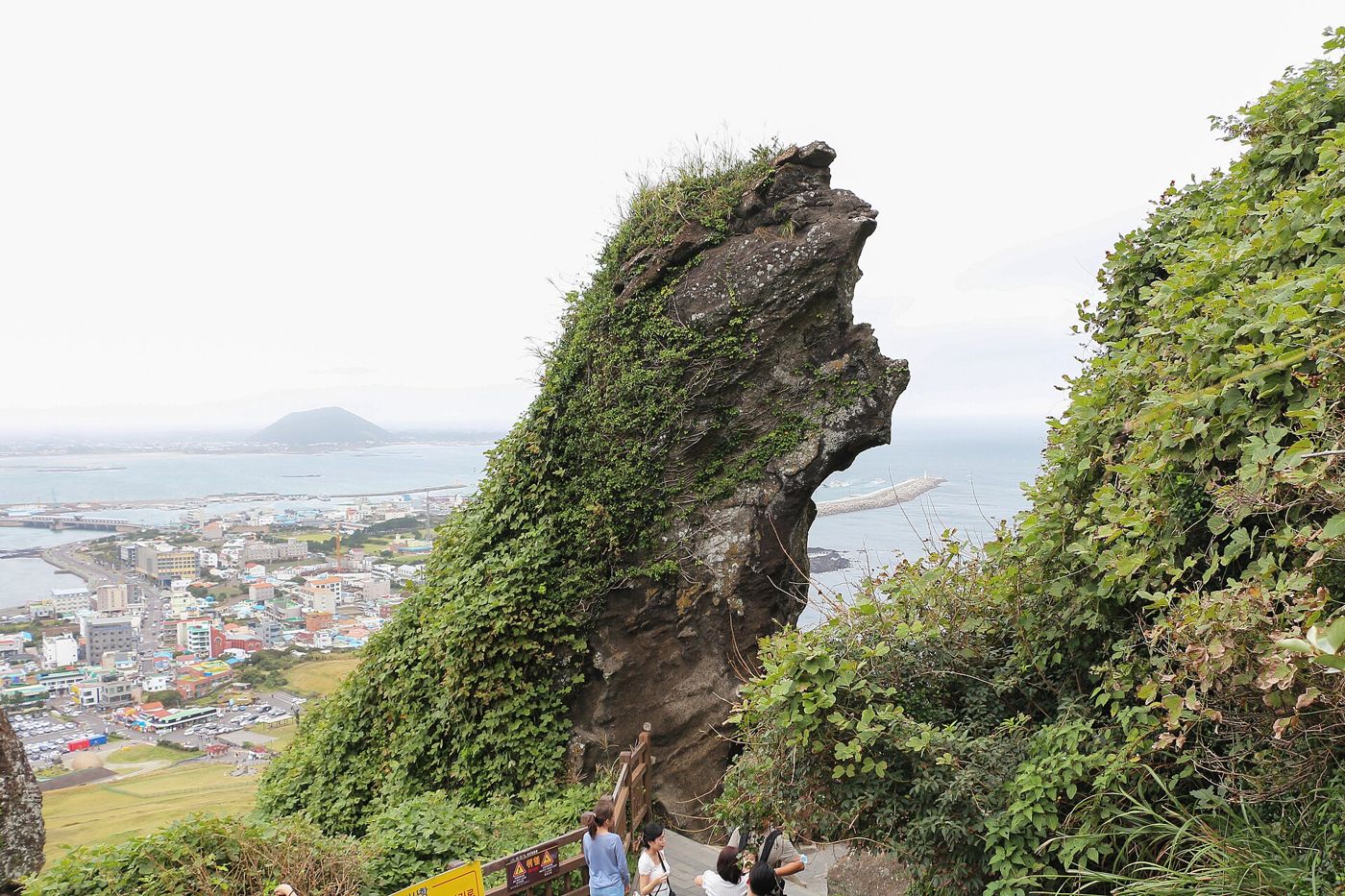 A rock pillar and Seongsan town seen from the Seongsan Ilchulbong trail